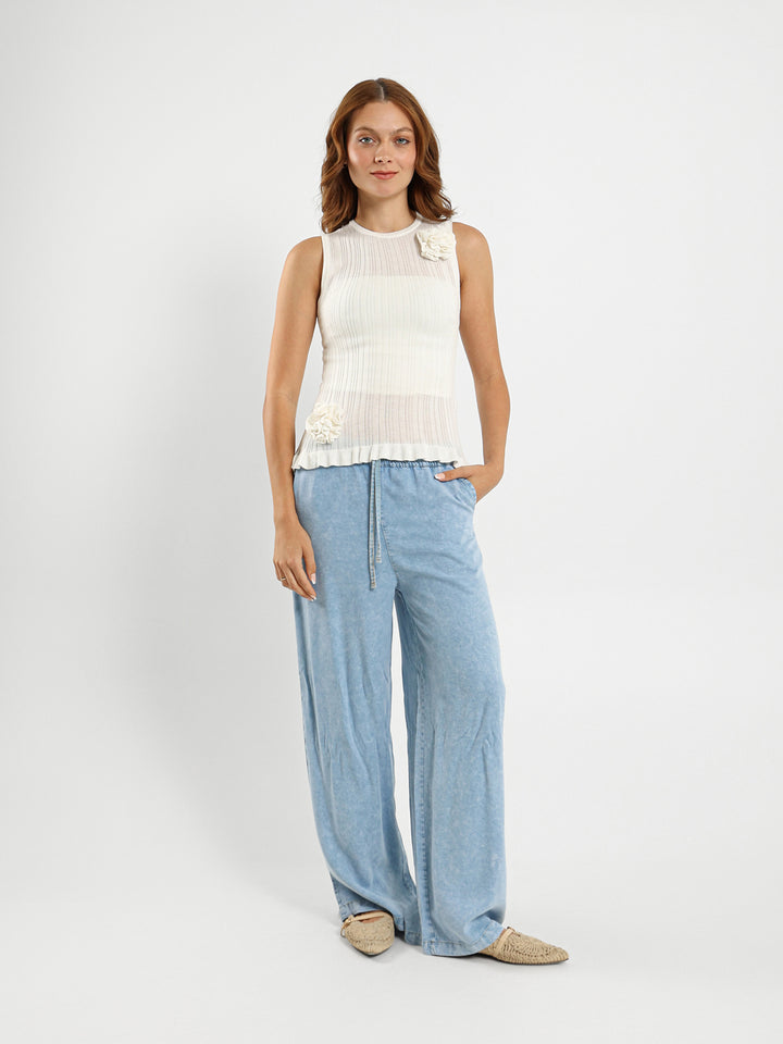 Sleeveless Top With Ruffle Hem And Flower Trim