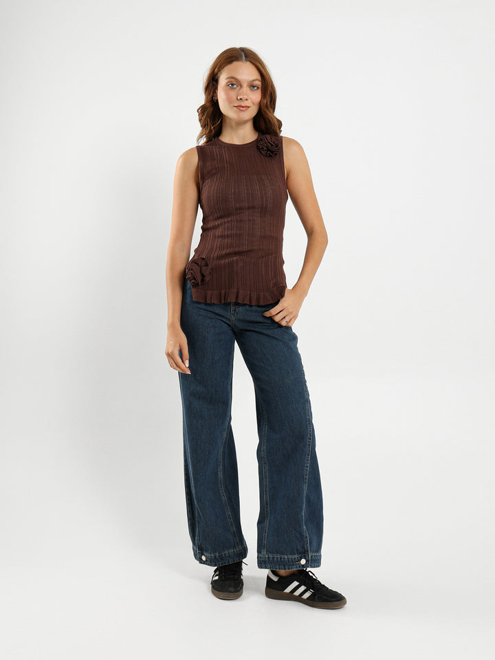 Sleeveless Top With Ruffle Hem And Flower Trim